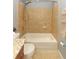 Tiled bathtub area features a showerhead and a toilet with granite countertops at 5165 Mystic Point Ct, Orlando, FL 32812