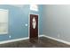 Bright entryway featuring a tall ceiling, wood-look flooring, fresh paint, and a decorative front door with sidelight at 5165 Mystic Point Ct, Orlando, FL 32812