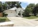Charming single-story home with a two-car garage and a well-maintained front yard with mature trees and landscaping at 5165 Mystic Point Ct, Orlando, FL 32812