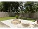 View of the backyard firepit, landscaping, and synthetic lawn at 5165 Mystic Point Ct, Orlando, FL 32812