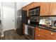 Well-equipped kitchen featuring stainless steel appliances and wooden cabinets at 5165 Mystic Point Ct, Orlando, FL 32812
