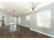 Bright living room boasts hardwood floors, pendant lighting and ample natural light at 5165 Mystic Point Ct, Orlando, FL 32812