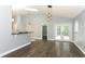 Open living room with hardwood floors leads into the kitchen and to the outdoor patio at 5165 Mystic Point Ct, Orlando, FL 32812