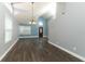 Spacious living room featuring updated flooring, fresh neutral paint, high ceilings, and modern chandelier at 5165 Mystic Point Ct, Orlando, FL 32812