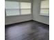 Bright bedroom with two large windows and sleek flooring; a serene retreat at 5416 Vance Ave, Orlando, FL 32810