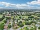 Scenic aerial view of a residential community with lush greenery and a golf course winding throughout at 5453 Grove Mnr, Lady Lake, FL 32159
