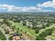 Aerial view of a home in a golf community surrounded by trees and lush landscaping at 5453 Grove Mnr, Lady Lake, FL 32159