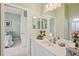 Bright bathroom with a vanity, a well-lit mirror, and a doorway leading to a bedroom for easy access at 5453 Grove Mnr, Lady Lake, FL 32159