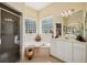 Well-lit bathroom features a soaking tub with unique glass-block windows and a separate glass-enclosed shower at 5453 Grove Mnr, Lady Lake, FL 32159
