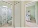 Clean bathroom includes a shower with patterned glass, a toilet, and access to a bedroom for convenience at 5453 Grove Mnr, Lady Lake, FL 32159