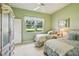 Comfortable bedroom featuring twin beds, a large window, and neutral decor for a calming atmosphere at 5453 Grove Mnr, Lady Lake, FL 32159