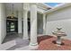 Grand entrance featuring stately columns, decorative fountain, and tiled walkway leading to the inviting front door at 5453 Grove Mnr, Lady Lake, FL 32159