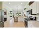 Well-lit kitchen with white cabinets, stainless steel appliances, and views to the backyard at 5453 Grove Mnr, Lady Lake, FL 32159