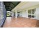 Spacious tiled lanai with screens and an open view of the backyard through sliding glass doors at 5453 Grove Mnr, Lady Lake, FL 32159