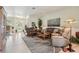 Inviting living room featuring plush leather furniture, tiled floors, a ceiling fan, and natural light at 5453 Grove Mnr, Lady Lake, FL 32159