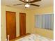 Bedroom featuring 2 closets, ceiling fan, and a window with blinds at 596 Starstone Dr, Lake Mary, FL 32746