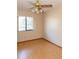 Bright bedroom with hardwood floors, a ceiling fan, and a large window for natural light, creating a comfortable space at 596 Starstone Dr, Lake Mary, FL 32746