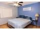 Bedroom featuring a queen bed with a blue comforter, and a window with blinds at 596 Starstone Dr, Lake Mary, FL 32746
