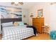 This cozy bedroom has a beach theme, a ceiling fan, and a comfortable bed at 596 Starstone Dr, Lake Mary, FL 32746