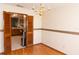 Traditional dining room with hardwood floors and a stylish chandelier, offering a glimpse into the kitchen at 596 Starstone Dr, Lake Mary, FL 32746