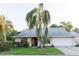 Charming single-story home with a well-manicured lawn and a grand palm tree in the front yard at 596 Starstone Dr, Lake Mary, FL 32746