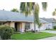 Charming single-story home with a well-manicured lawn and a grand palm tree in the front yard at 596 Starstone Dr, Lake Mary, FL 32746