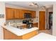 This bright kitchen has wood cabinets, stainless steel appliances, and a mosaic backsplash at 596 Starstone Dr, Lake Mary, FL 32746