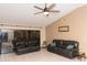 Spacious living room with vaulted ceiling, tile flooring, two couches, and a sliding glass door, perfect for relaxing at 596 Starstone Dr, Lake Mary, FL 32746