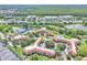 Aerial of condo community featuring lush landscapes, multiple buildings, swimming pool and nearby lakes at 6337 Parc Corniche Dr # 2312, Orlando, FL 32821