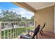 Relaxing balcony with chairs overlooking green space and mature trees offers serene outdoor living at 6337 Parc Corniche Dr # 2312, Orlando, FL 32821