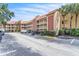 Condominium exterior showing multiple stories, balconies, parking area, and well-maintained landscaping at 6337 Parc Corniche Dr # 2312, Orlando, FL 32821