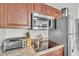 Close up of modern kitchen featuring granite counters, stainless appliances, and cookware at 6337 Parc Corniche Dr # 2312, Orlando, FL 32821