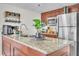 Well-lit kitchen featuring granite countertops and stainless steel appliances at 6337 Parc Corniche Dr # 2312, Orlando, FL 32821