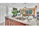 Open kitchen with island featuring granite countertop and view to dining and living areas at 6337 Parc Corniche Dr # 2312, Orlando, FL 32821