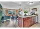 Open kitchen featuring granite countertops, stainless appliances, and stylish furnishings at 6337 Parc Corniche Dr # 2312, Orlando, FL 32821