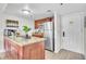 Bright kitchen featuring an island with granite countertops and stainless steel appliances at 6337 Parc Corniche Dr # 2312, Orlando, FL 32821