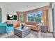 Cozy living room featuring stylish furniture, modern flooring, and large bright windows at 6337 Parc Corniche Dr # 2312, Orlando, FL 32821