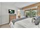 Well-appointed main bedroom boasting a TV, balcony, and comfortable furnishings for a restful stay at 6337 Parc Corniche Dr # 2312, Orlando, FL 32821