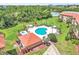 Aerial view of community pool area including a hot tub, splash pad, playground, and grilling area at 6337 Parc Corniche Dr # 2312, Orlando, FL 32821
