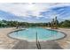 Community pool with zero entry, lush landscaping, and lounge seating at 6615 Leo Ln, St Cloud, FL 34773