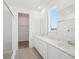 Bright bathroom with double vanity, ample counter space, walk-in closet access, and tile flooring at 6723 Sherpa Trl, St Cloud, FL 34771