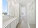 Modern bathroom with a white vanity, quartz countertop, and a sleek glass-enclosed shower at 6723 Sherpa Trl, St Cloud, FL 34771
