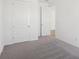 Carpeted bedroom with a pair of white doors and neutral colored walls at 6723 Sherpa Trl, St Cloud, FL 34771