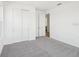 Carpeted bedroom with a pair of white doors and neutral colored walls at 6723 Sherpa Trl, St Cloud, FL 34771