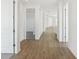 Bright hallway featuring beautiful wood-look flooring and white doors leading to other rooms at 6723 Sherpa Trl, St Cloud, FL 34771