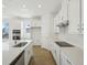 Bright kitchen with stainless appliances, white cabinets, an island and hard surface countertops at 6723 Sherpa Trl, St Cloud, FL 34771