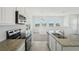 Modern kitchen with granite countertops, stainless steel appliances, and lots of natural light at 6723 Sherpa Trl, St Cloud, FL 34771