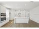 Modern kitchen with stainless steel appliances, white cabinets, and a large center island at 6723 Sherpa Trl, St Cloud, FL 34771