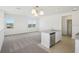 Spacious living area with a kitchen island, modern lighting, and large windows for natural light at 6723 Sherpa Trl, St Cloud, FL 34771