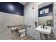 Bathroom with patterned accent wall, modern fixtures, and decorative mirror at 7053 Painted Bunting Way, St Cloud, FL 34773